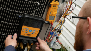Peterman tech looking at gauge on ac